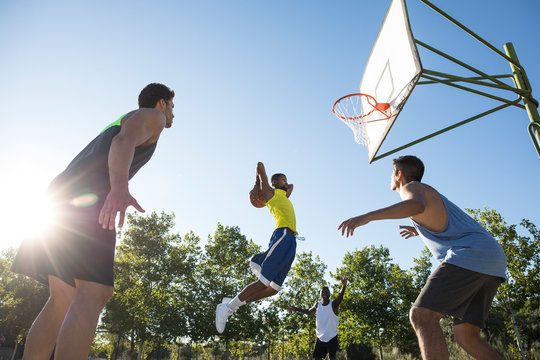 Group of people running and jumping while playing streetball