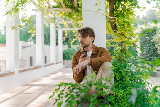 Barcelona, Spain. Business man outdoors. Casual, job, outdoor office, digital, digital nomad, millennial, young man, daytime, work, laptop, technology