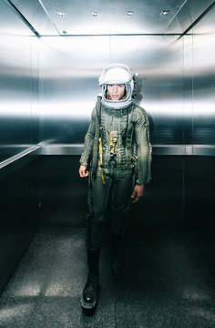 Man posing dressed as an astronaut in an elevator