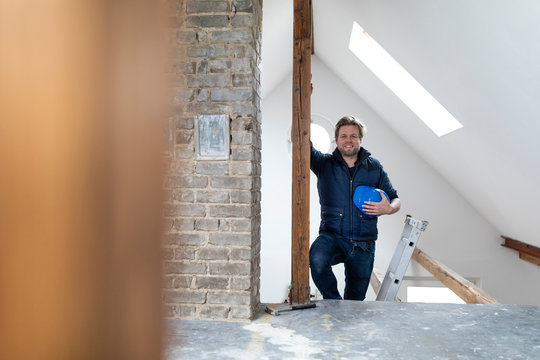 Architect standing on construction site of a loft conversion