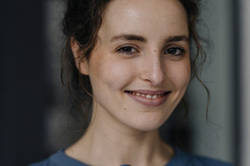 Portrait of smiling young woman with brown eyes