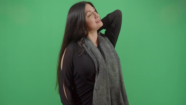 Woman Scratching His Back. Studio Isolated Shot Against Green Screen Background
