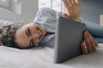 Portrait of happy young woman during video chat at home