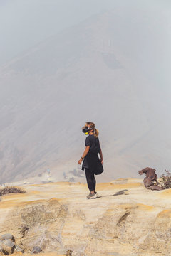 Young woman with espirator mask at Ijen volcano, Java, Indonesia