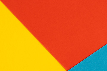 Yelllow blue red color paper background. Geometric figures, shapes. Abstract geometric flat composition. Empty space on monochrome cardboard.