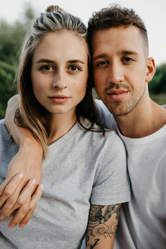 Portrait of young couple, arm around