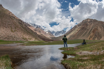 Fototapeta na wymiar Couple fishing in the Andes mountains