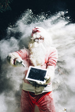 Santa Claus showing digital tablet