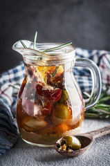 glass decanter with olives and pepper with cheese in olive oil