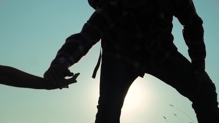 teamwork Silhouette of helping hand hikers help business travel silhouette concept. happy family couple group of tourists happy family lends a helping hand climb the cliffs mountains. people two