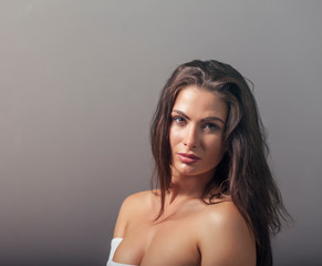 Naklejka premium Portrait of a beautiful young brunette with long hair and professional makeup
