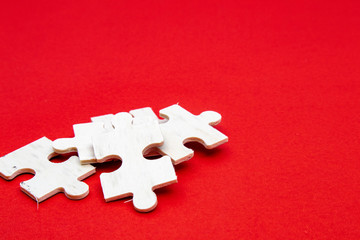 white wooden jigsaw puzzle on a red background For practicing meditation, problem-solving skills,...