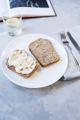 stylish and cozy pastel-colored breakfast with sandwiches of bread and cottage cheese with almonds
