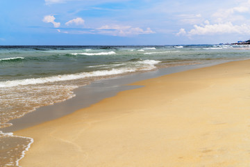 Fototapeta na wymiar Sandy beach against blue cloudy sky. Da Nang, Vietnam