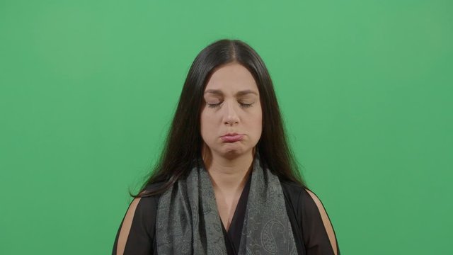 Facial Expression Of A Woman Pouting. Studio Isolated Shot Against Green Screen Background