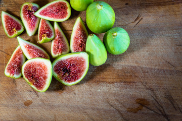 Fig - fresh figs and sliced fig fruits close-up on cutting board