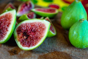 Fig - fresh figs and sliced fig fruits close-up on cutting board