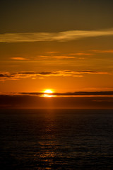 Obraz premium SSunset over the ocean viewed from a cruise ship a beautiful golden glow.