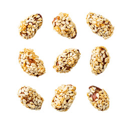 Set of almonds covered sesame seeds on a white, isolated. The view of the top.