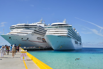 Cruise shi[s docked in harbour at tropical port awaiting guests 