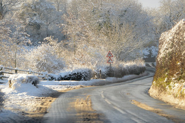 Snow covered roads in rural Shropshire UK causing dangerous driving conditions for road users, but a beautiful  christmassy scene.