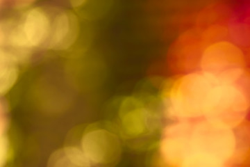 Abstract bokeh autumn colors background. Green, orange and yellow. Design backdrop.