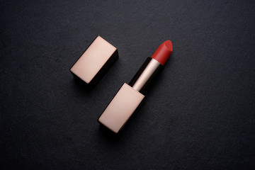 Bronze finished Lipstick make up on a dark slate stone background