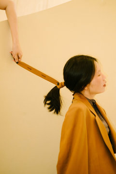Portrait of woman with hair wrapped in leather strap