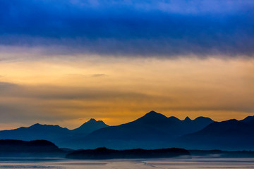 Sunset over Ocean and Mountains Silhouetted