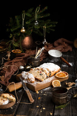 christmas dessert stollen with dried fruits, berries, nuts and powdered sugar on top