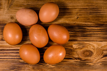 Pile of the hen eggs on wooden table. Top view