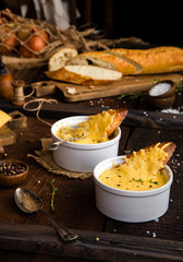 french onion soup, melted cheese and slice of baguettefrench onion soup, melted cheese and slice of baguette