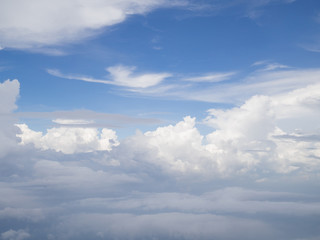 Naklejka na ściany i meble Clouds from airplane window with blue sky