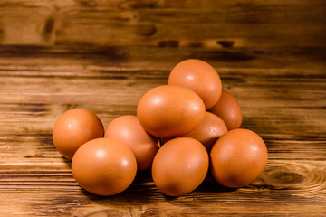 Pile of the hen eggs on wooden table