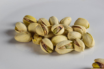 several pistachios on a white back ground