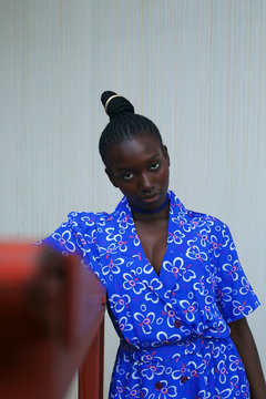 Portrait of woman in dress posing outdoors