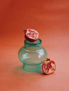 Balanced pomegranate on glass jar