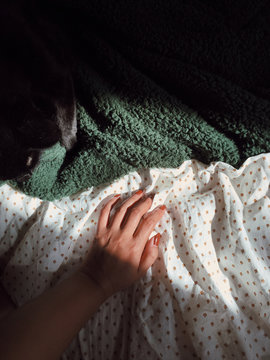 Close up of woman's hand touching textile