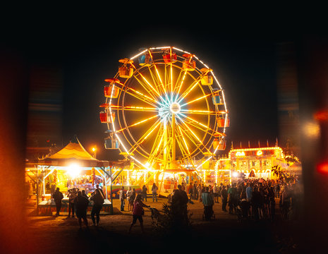 People enjoying fair at night
