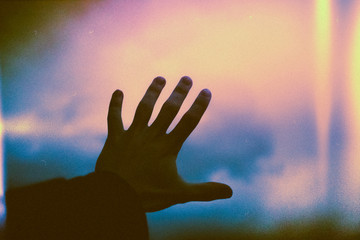 Close up of man's hand touching window glass