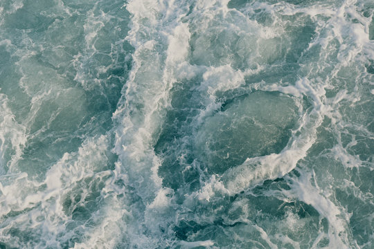 View of ocean with large waves going in different directions