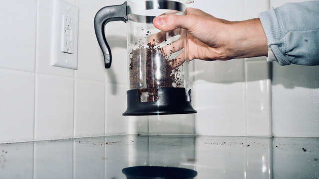 Close up of man's hand holding coffee maker