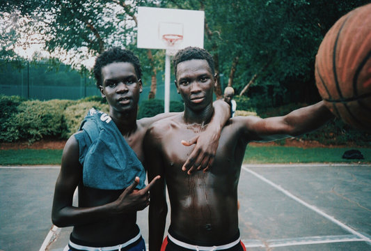 Portrait of two boys posing after playing basketball
