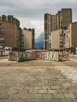 Graffiti covered wall in front of buildings