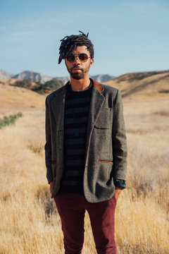 Portrait of man wearing suit jacket in field