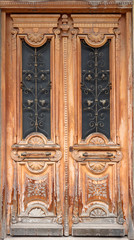 Old wooden door with carved ornaments.