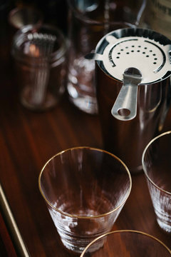 Close up of barware on wooden bar cart
