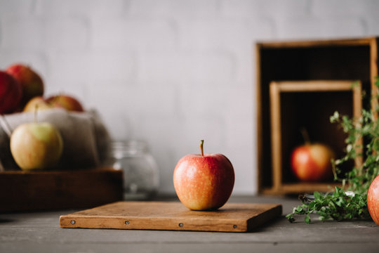 Apple on wooden cutting board