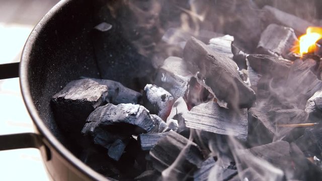 cooking, heat and fire concept - charcoal burning in brazier outdoors