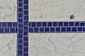 Blue square tiles on concrete surface